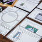 Assorted worksheets and task cards related to Pythagoras' theorem spread out on a table, with writing and illustrations on them.